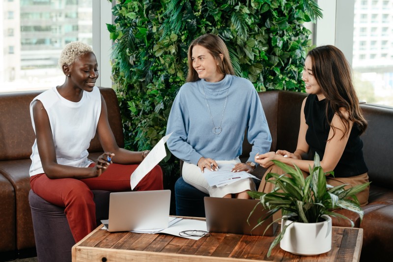 Three women in an office discussing business
